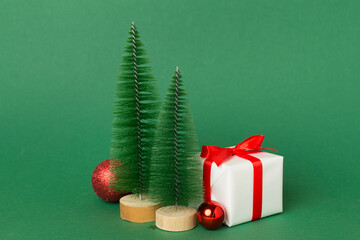 Small christmas trees with decoration on color background