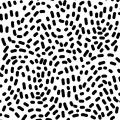 Hand Drawn dash pattern. Seamless pattern with small black lines on a white background