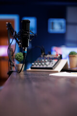 Podcast microphone for live streaming used to record content discussions for internet channels. Closeup of professional mic used for live online talk shows, broadcasted in a home studio.