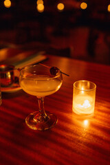 Last Word cocktail in coupe glass at red lit bar, restaurant