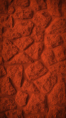 A vertical 4K background featuring a striking red grainy stone wall texture. Ideal for bold wallpapers, banners, and backdrops with a rugged, natural feel