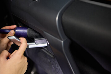 Fototapeta premium Car Interior Cleaning process underway with a brush for detailed professional detailing