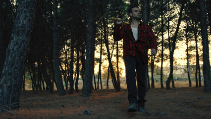 Fototapeta premium Murder Man With Axe Walk In The Forest To Find Victims