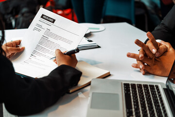 Human resources department manager reads CV resume document of an employee candidate at interview...
