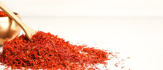 Heap of aromatic saffron on light background with space for text