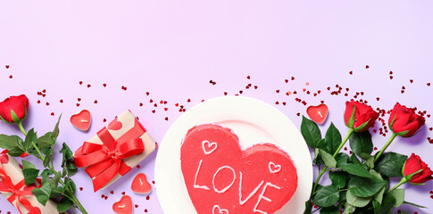 Tasty heart-shaped bento cake for Valentine's Day with rose flowers and gifts on lilac background