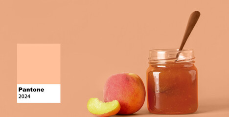 Jar with sweet peach jam and fresh fruits on orange background
