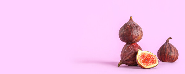 Fresh juicy cut figs on lilac background