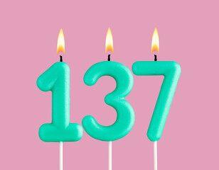 Green candle number 137 - Birthday card on pastel pink background