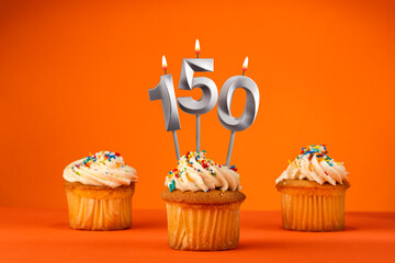 Candle number 150 - Celebration with birthday cupcake on orange background