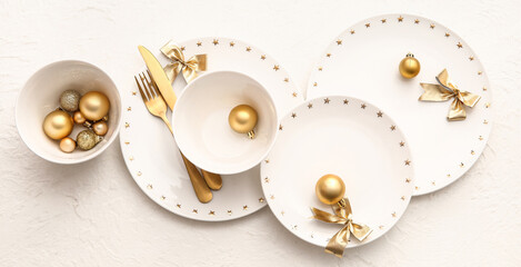 Beautiful table setting with Christmas balls and bows on white background