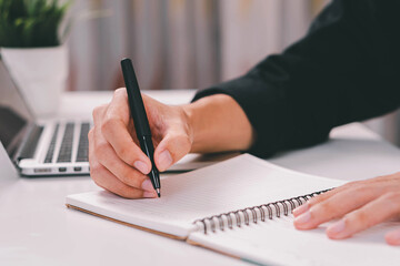 Male hand taking notes on the notepad. businessman working at work table, checklist writing planning investigate enthusiastic concept. focus on man hand holding pen, putting signature at official pape