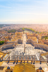 Visitors gather in St. Peter's Square, enjoying a warm sunset over Vatican City. The iconic Basilica and obelisk stand prominently, showcasing the beauty and significance of this historic location.