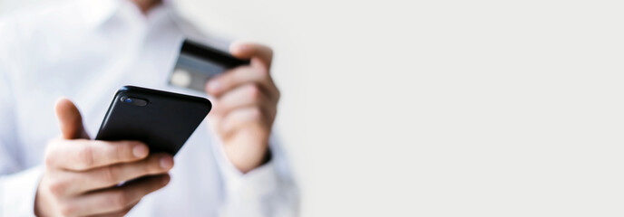 Man with smartphone and credit card