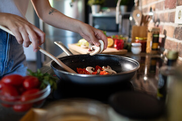 Young woman preparing fresh vegetables in a modern kitchen