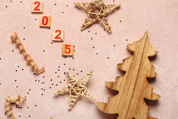 Christmas composition with wooden fir tree, text 2024 and decor on beige background, closeup
