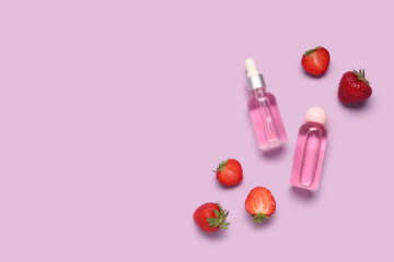 Composition with bottles of cosmetic products and fresh strawberry on color background