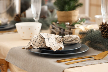 Christmas table setting with plates, cutlery and napkin, closeup
