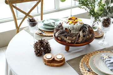 Festive table setting for Christmas dinner in modern living room