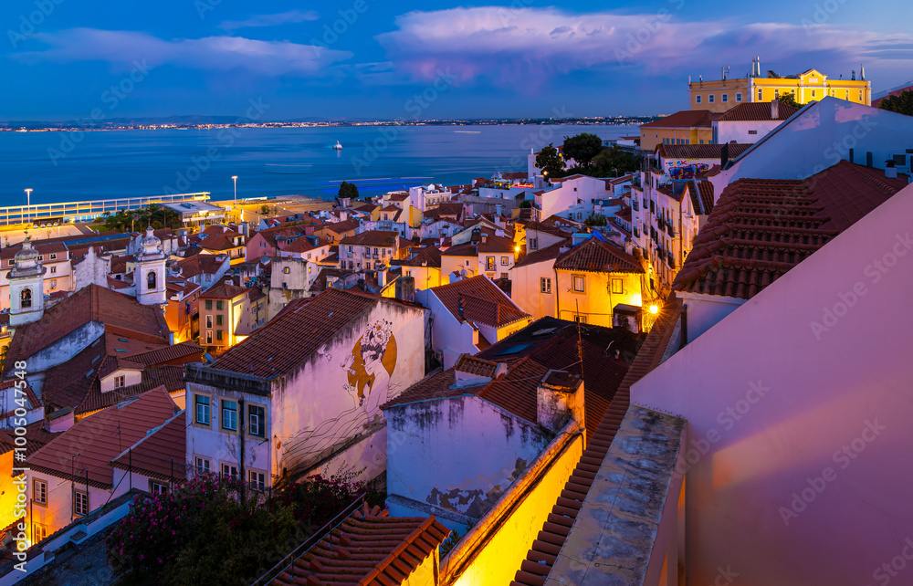 Wall mural Twilight view of Alfama, one of Lisbon’s oldest areas with shops selling traditional crafts and cafes, Portugal