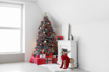 Interior of festive living room with gift boxes under Christmas tree and fireplace