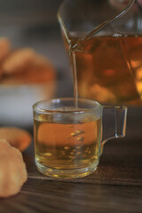 Hot tea drink with Mini castella cake, Traditional Thai egg cake or Khanom Khai made with egg and sugar, soft dough. Delicious local dessert