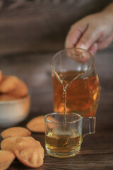 Hot tea drink with Mini castella cake, Traditional Thai egg cake or Khanom Khai made with egg and sugar, soft dough. Delicious local dessert