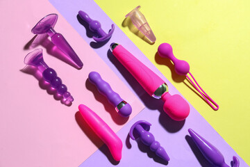 Many different sex toys on color background
