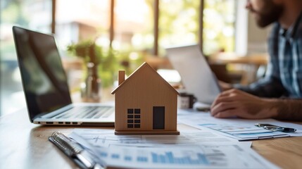 Analyzing Home Investment Strategy on Laptop in Workspace