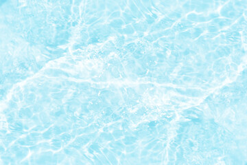 Blue water with ripples on the surface. Defocus blurred transparent blue colored clear calm water surface texture with splashes and bubbles. Water waves with shining pattern texture background.