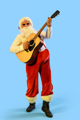 Cool Santa Claus playing guitar on blue background