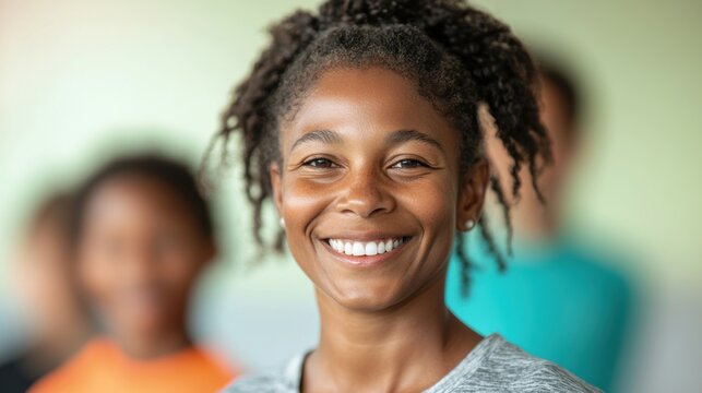 A cheerful female PE teacher engages with her students during an outdoor sports class, fostering teamwork and positivity