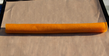 Apricot Fruit Roll Up Long Roll Homemade on Square Food Dehydrator Shelf