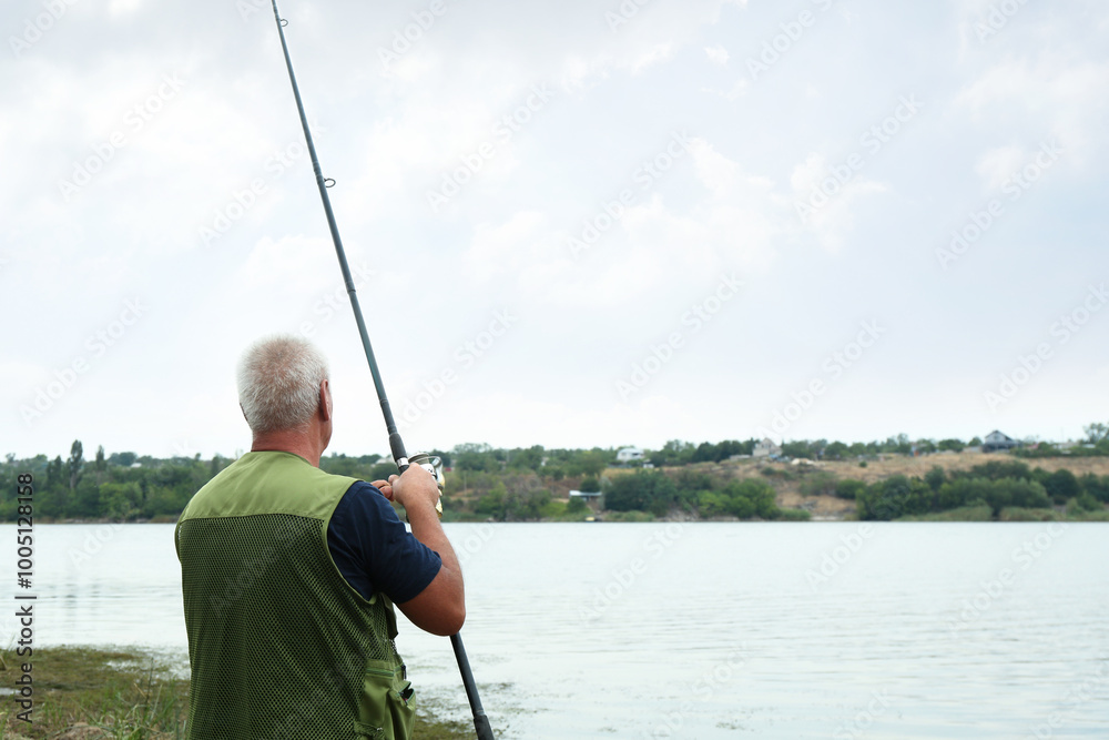 Sticker Fisherman with rod fishing near lake at summer, back view