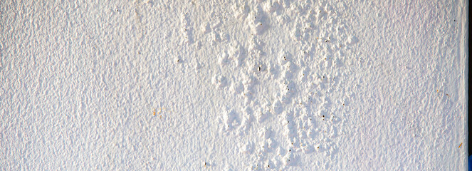 White paint on the wall of the house. Texture, background.