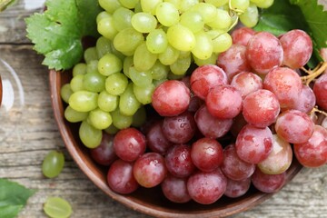 Fresh ripe grapes on wooden table, top view