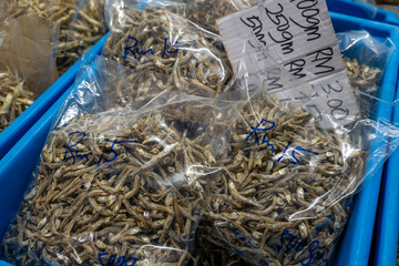 This image offers a fascinating glimpse into the world of preserved seafood, showcasing a diverse array of dried fish and other marine delicacies.  