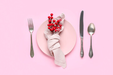 Beautiful Christmas table setting with rowan on pink background