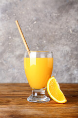 Glass of fresh orange juice on wooden table