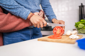 Newlywed couple cooking together in their kitchen