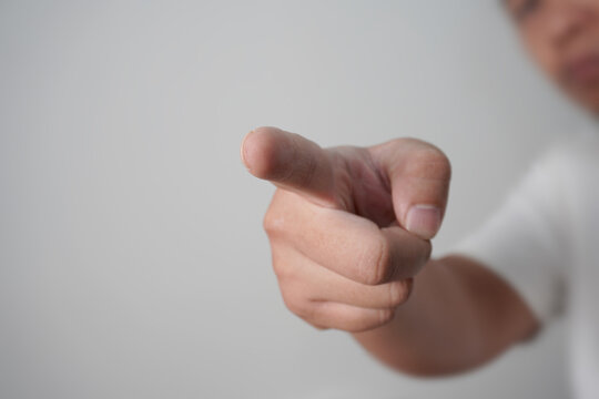 Anonymous man pointing forward, focus on finger with blurred face