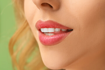 Fototapeta premium Young woman with beautiful lipstick on green background, closeup