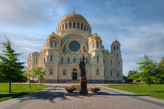 Monument to Admiral Fyodor Ushakov on the background of the Naval Cathedral of St. Nicholas (Naval St. Nicholas Cathedral) on a sunny summer morning, Kronstadt, St. Petersburg, Russia
