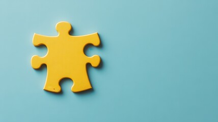 Obraz premium Yellow puzzle piece on a light blue background, isolated view.