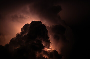 Thunderstorm Dark clouds illuminated by flashes of lightning and booming thunders
