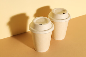 Paper cups with lids on a light background