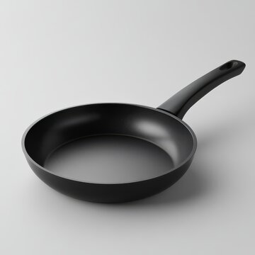 High-quality non-stick black frying pan with an ergonomic handle. Ideal for everyday cooking. Isolated on a plain background.