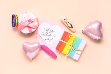 Gift boxes with festive postcard and vibrators on beige background. Valentine's Day celebration