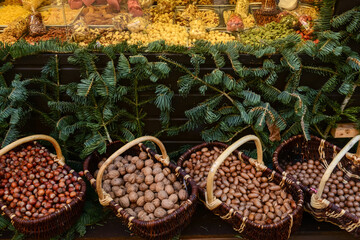Baskets with nuts near stall at Christmas fair