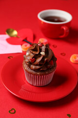 Plate with sweet cupcake on red background, closeup. Valentine's Day celebration